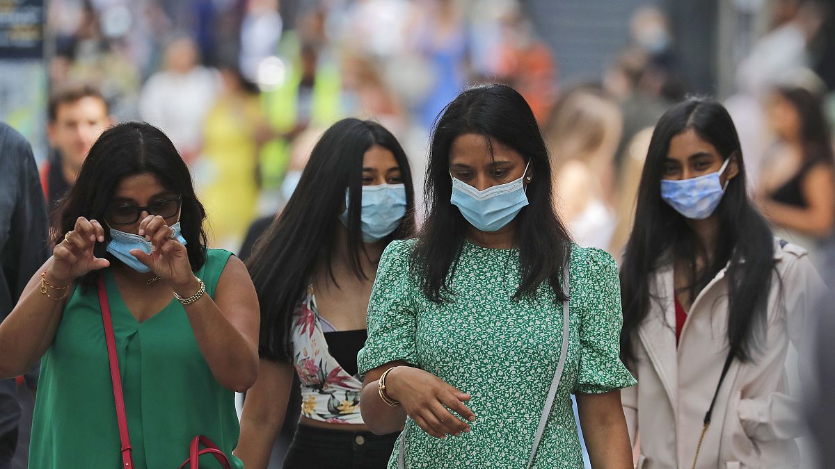 Shoppers wear face coverings to protect themselves from COVID-19 as they walk along Oxford Street in London, July 24, 2020. 