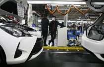 Employee wearing a face masks stand by the production chain of the Yaris car at the Toyota car factory in Onnaing, northern France