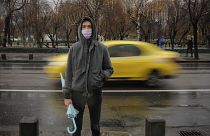 A man wears a mask during an anti-pollution protest outside the city hall in Bucharest, Romania