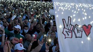 Supporters of presidential candidate Svetlana Tikhanovskaya turn on flashlights on their phones during her campaign rally in Minsk on July 30, 2020.