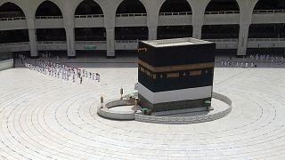 Muslim pilgrims line up to leave after they circled the Kaaba, the cubic building at the Grand Mosque,