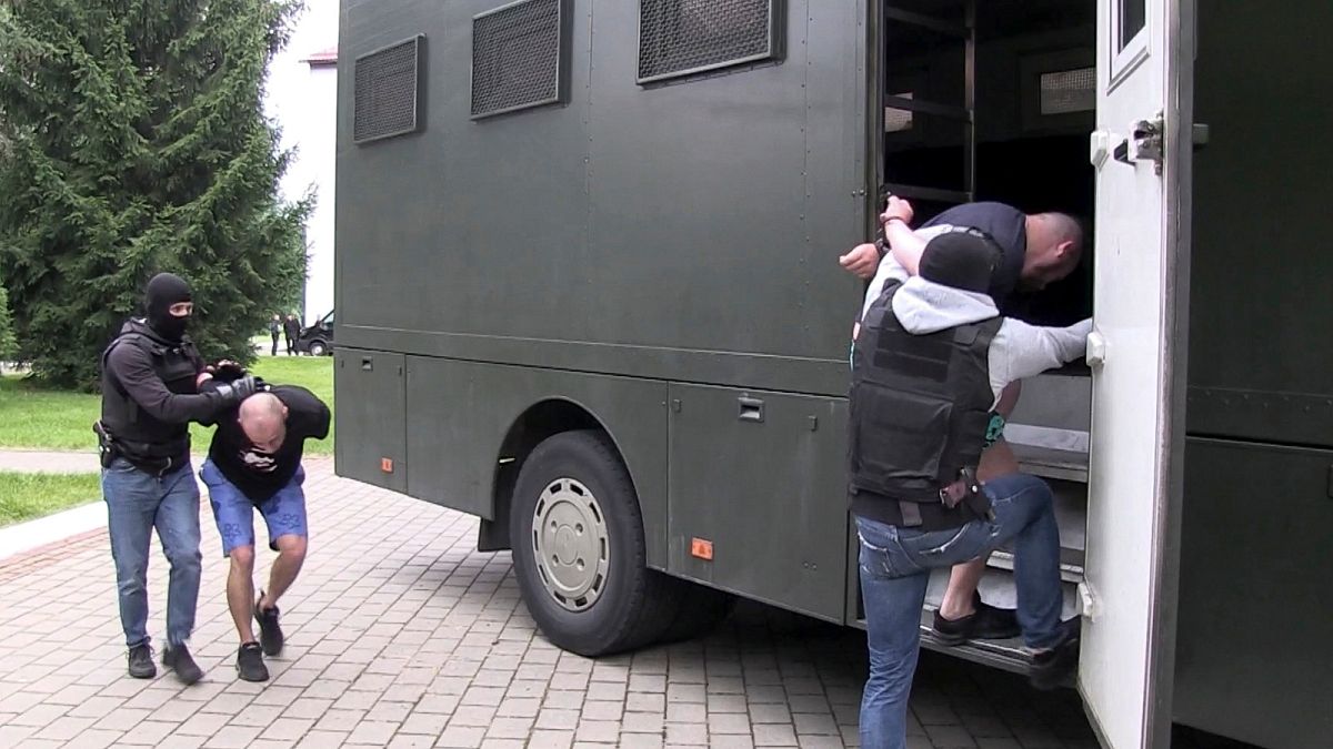 In this photo taken from video released by Belarusian KGB, State TV and Radio Company of Belarus on Wednesday, July 29, 2020, Belarusian KGB officers detain Russian men.