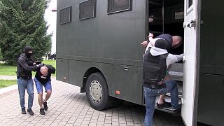 In this photo taken from video released by Belarusian KGB, State TV and Radio Company of Belarus on Wednesday, July 29, 2020, Belarusian KGB officers detain Russian men.