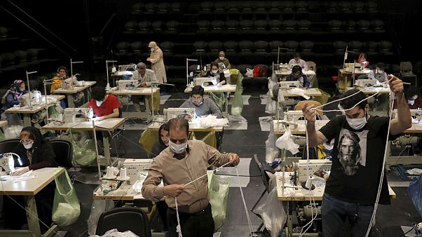 Volunteers wearing face masks to curb the spread of the new coronavirus, sew face masks for poor people, at the Hafez theatre hall in downtown Tehran, Iran Volunteers wearing face masks to curb the spread of the new coronavirus, sew face masks for poor people, at the Hafez theatre hall in downtown Tehran, Iran