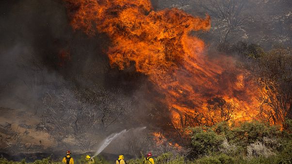 Firefighters work against the Apple Fire near Banning, Calif., Sunday, Aug. 2, 2020 Firefighters work against the Apple Fire near Banning, Calif., Sunday, Aug. 2, 2020