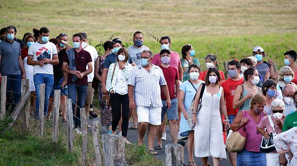 People wear face masks as they leave a music festival in Saint Etienne de Baigorry, southwestern France, Sunday, July 26, 2020. People wear face masks as they leave a music festival in Saint Etienne de Baigorry, southwestern France, Sunday, July 26, 2020.