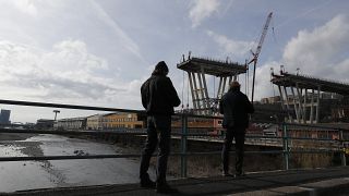 People look the Morandi bridge in Genoa, Italy, Saturday, Feb. 9, 2019.