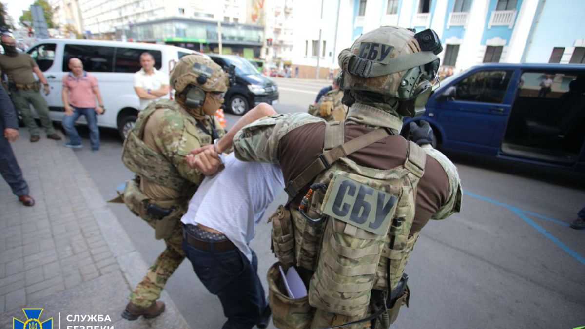 Officers from Ukraine's Security Service detain a man who threatened to blow up a bank in Kyiv on Monday, August 3, 2020.
