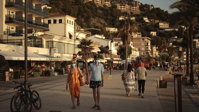 Tourists and locals walk in town of Sóller in the Balearic Island of Mallorca, Spain