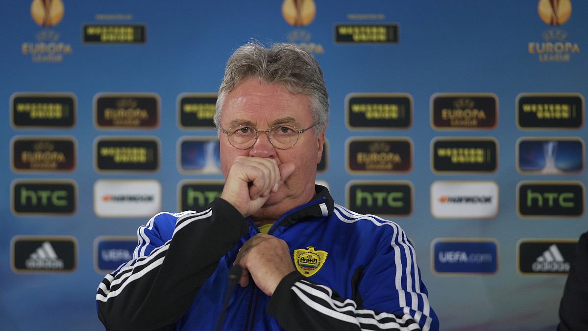 Anzhi's head coach Guus Hiddink of Netherlands coughs during a news conference