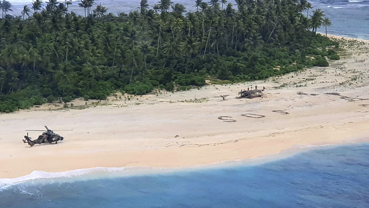 In this photo provided by the Australian Defence Force, three men stand the beach on Pikelot Island in the Federated States of Micronesia