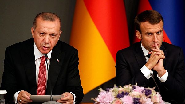 Turkey's President Recep Tayyip Erdogan, left, sits by French President Emmanuel Macron during a news conference following a summit on Syria, in Istanbul, Saturday, Oct. 27, 2 Turkey's President Recep Tayyip Erdogan, left, sits by French President Emmanuel Macron during a news conference following a summit on Syria, in Istanbul, Saturday, Oct. 27, 2