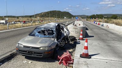 A damaged car sits in toll stations still under construction in the village of Ardanio, near Alexandroupolis