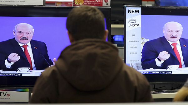 Belarus's President Alexander Lukashenko is seen on TV screens inside a shop Belarus's President Alexander Lukashenko is seen on TV screens inside a shop