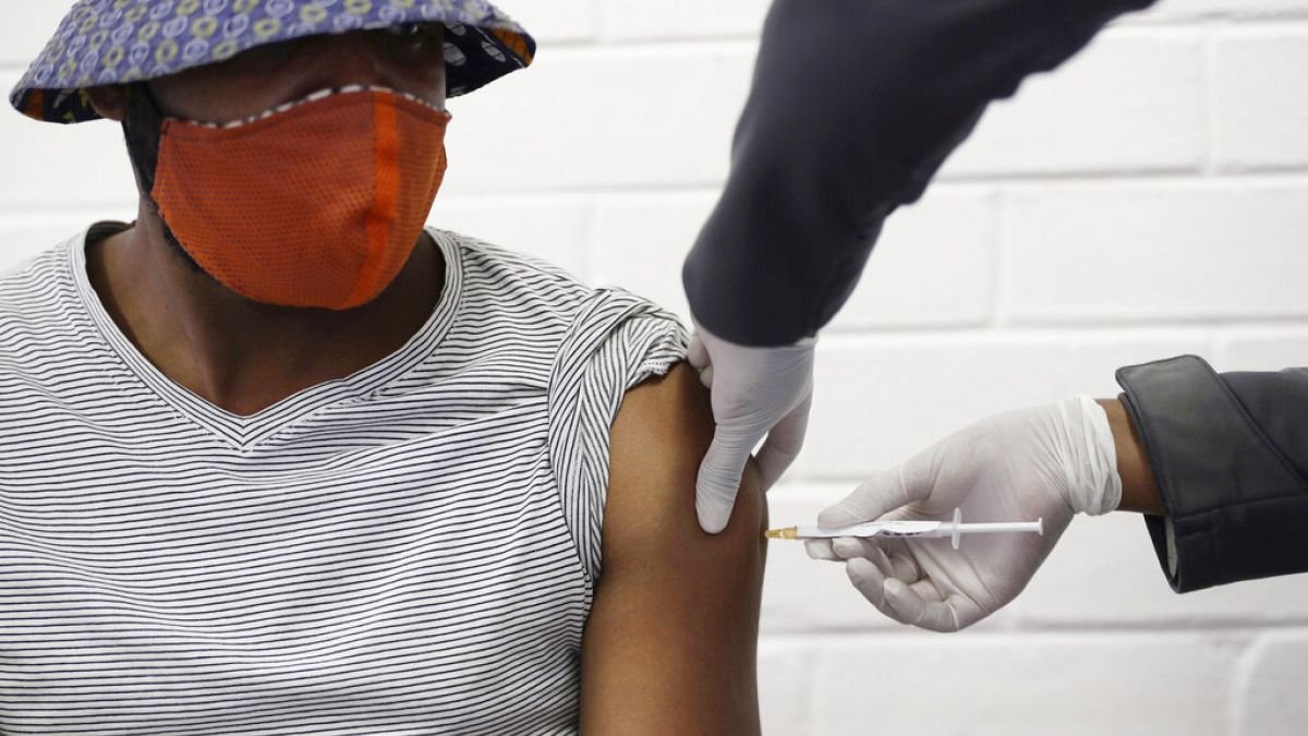 a volunteer receives a COVID-19 test vaccine injection developed at the University of Oxford in Britain, June 24, 2020