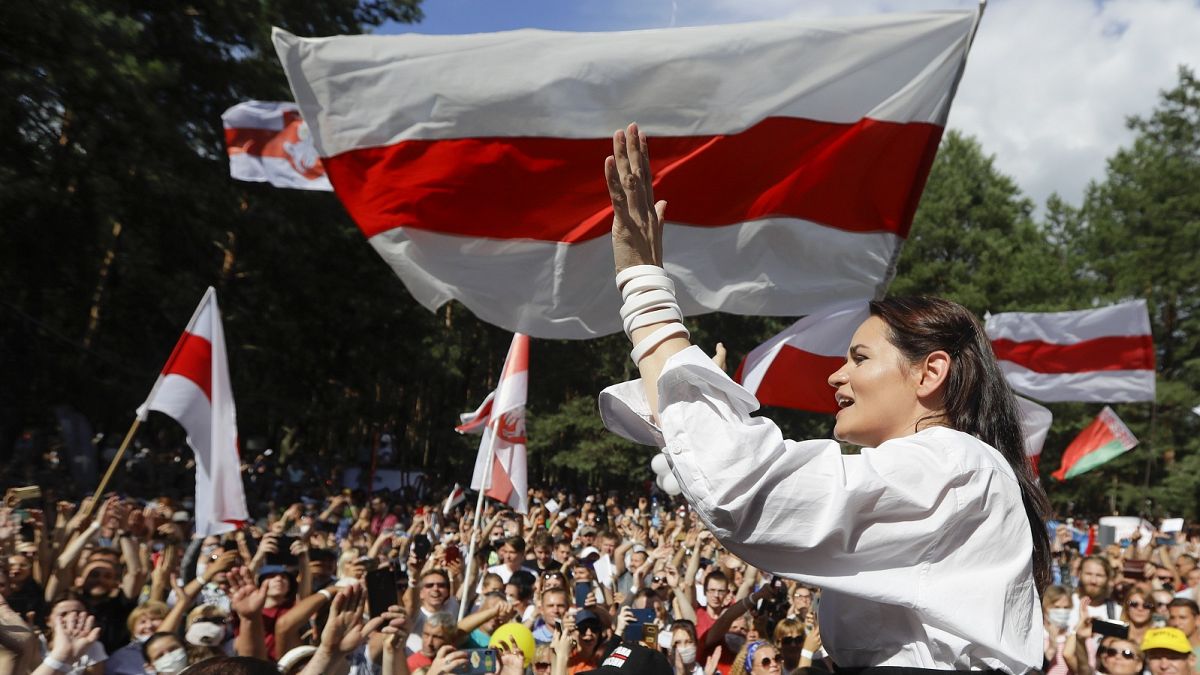Sviatlana Tsikhanouskaya, candidate for the presidential elections, greets people waving old Belarus flags during a rally in Brest, Belarus.