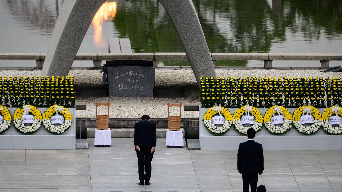 Japanese Prime Minister Shinzo Abe bows in front of the Memorial Cenotaph during the 75th anniversary memorial service