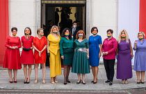 Left wing parliamentarians dressed in the colours of the rainbow pose in front of the Polish Parliament (Sejm)