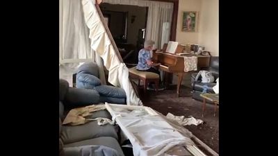 Elderly lady plays piano in damaged Beirut apartment