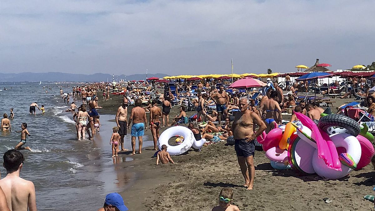 People enjoy the beach in Fregene, a fashionable sea resort some 30km (19 miles) north of Rome, Sunday, July 26, 2020.