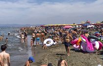 People enjoy the beach in Fregene, a fashionable sea resort some 30km (19 miles) north of Rome, Sunday, July 26, 2020.