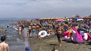 People enjoy the beach in Fregene, a fashionable sea resort some 30km (19 miles) north of Rome, Sunday, July 26, 2020.