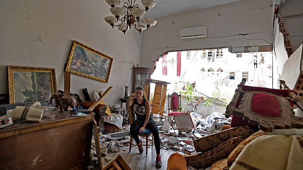 A woman sits among the rubble in her damaged house in the Lebanese capital Beirut on August 6, 2020, after a massive explosion shook the city A woman sits among the rubble in her damaged house in the Lebanese capital Beirut on August 6, 2020, after a massive explosion shook the city
