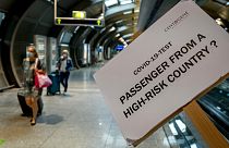 A sign helps passengers to find the COVID-19 test center at the airport in Frankfurt, Germany, Saturday, Aug. 8, 2020