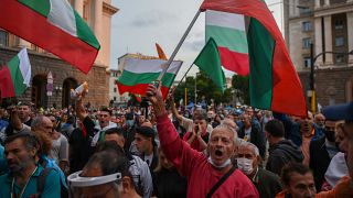 Protesters shout slogans and wave Bulgarian flags during an anti-government demo in Sofia, on August 5, 2020