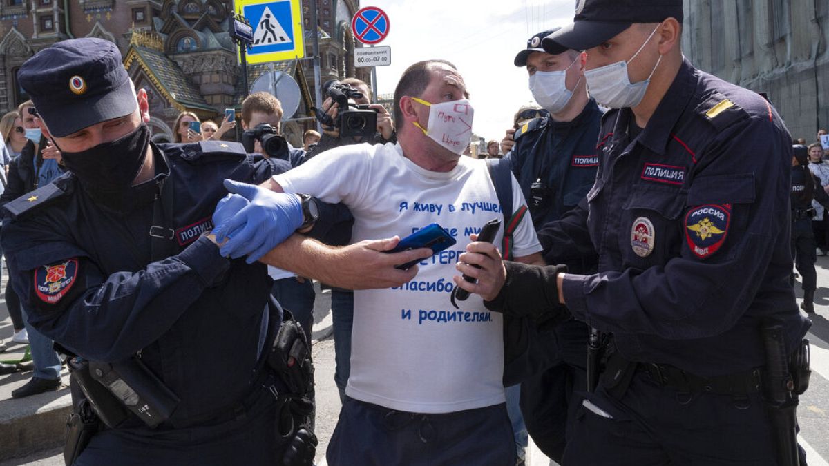 Police detain a protester during a rally supporting Khabarovsk region's governor Sergei Furgal in St.Petersburg, Russia, Saturday, Aug. 1, 2020