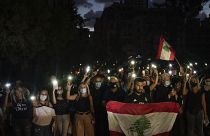 Demonstrators march holding candles and flashlights honoring the victims of the deadly explosion at Beirut port which devastated large parts of the capital, in Beirut, Lebanon