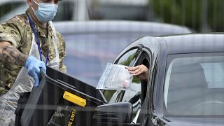 FILE - In this file photo dated Tuesday June 30, 2020, a coronavirus test sample is collected at a coronavirus testing station in Leicester, England. 