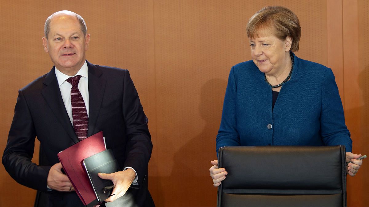 German Chancellor Angela Merkel arrives besides Vice Chancellor and Finance Minister Olaf Scholz 