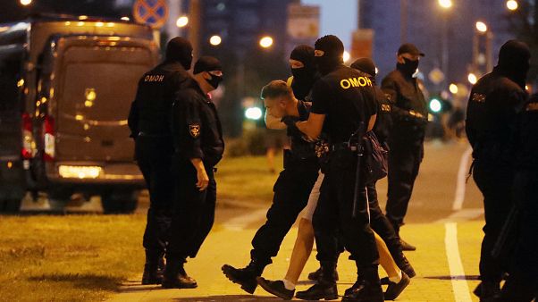 A police officer detain a protester during a rally after the Belarusian presidential election in Minsk, Belarus. Aug. 9, 2020. A police officer detain a protester during a rally after the Belarusian presidential election in Minsk, Belarus. Aug. 9, 2020.
