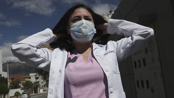 Dr. Maria Jose Casco adjusts her hair as she walks near her home in Quito, Ecuador, Wednesday, Aug. 5, 2020. Dr. Maria Jose Casco adjusts her hair as she walks near her home in Quito, Ecuador, Wednesday, Aug. 5, 2020.