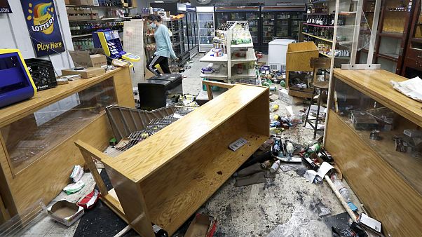 Kajal Dalal walks through her family's food and liquor store Monday, Aug. 10, 2020, after it was vandalized in downtown Chicago
