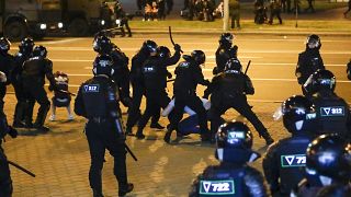 Police use truncheons on protesters during a mass protest following presidential election in Minsk, Belarus, Monday, Aug. 10, 2020. 