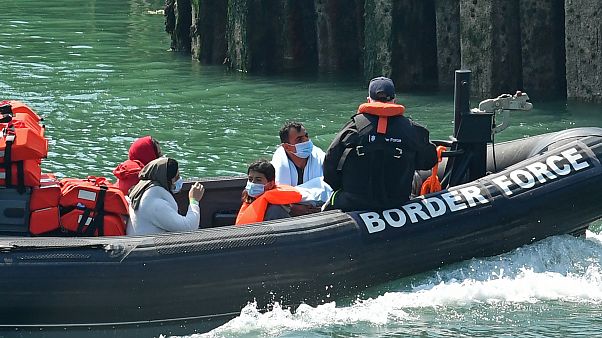 A UK Border Patrol dinghy brings a group of migrants, believed to have been picked up from boats in the Channel, into harbour at the port of Dover, England, August 9, 2020. A UK Border Patrol dinghy brings a group of migrants, believed to have been picked up from boats in the Channel, into harbour at the port of Dover, England, August 9, 2020.