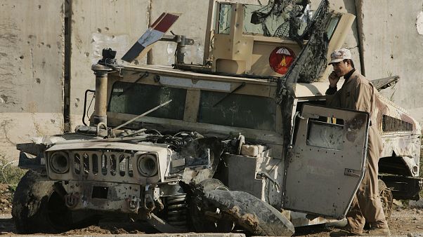 An Iraqi army soldier talks on his phone as he stands next to an army vehicle damaged in previous fighting, at an Iraqi army base in Sukor neighborhood An Iraqi army soldier talks on his phone as he stands next to an army vehicle damaged in previous fighting, at an Iraqi army base in Sukor neighborhood
