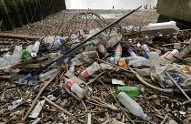2018 file photo, plastic bottles and other plastics including a mop, lie washed up on the north bank of the River Thames in London.