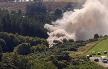 A still image taken from video footage shows smoke billowing from the scene of a train crash near Stonehaven in northeast Scotland on August 12, 2020.