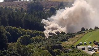 A still image taken from video footage shows smoke billowing from the scene of a train crash near Stonehaven in northeast Scotland on August 12, 2020.