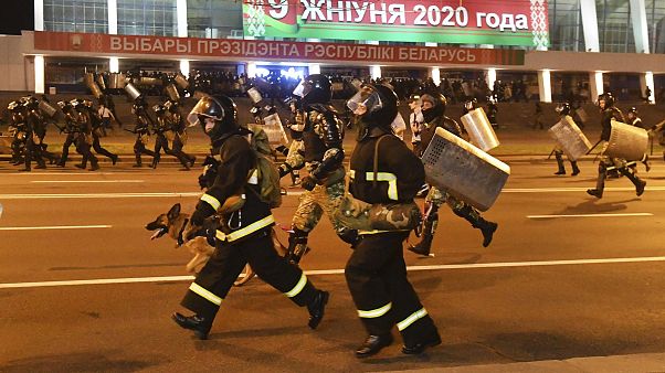 Police run to block demonstrators during a rally after the Belarusian presidential election in Minsk, Belarus, late Sunday, Aug. 9, 2020. Police run to block demonstrators during a rally after the Belarusian presidential election in Minsk, Belarus, late Sunday, Aug. 9, 2020.