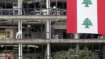 A picture of victims is displayed inside their damaged apartment facing the port of Beirut.