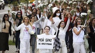 Belarusian women, one with a poster reading "My brother is not a criminal", rally in solidarity with protesters caught up in the state post-election crackdown, Minsk, Aug. 13.