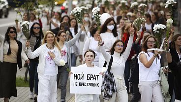 Belarusian women, one with a poster reading "My brother is not a criminal", rally in solidarity with protesters caught up in the state post-election crackdown, Minsk, Aug. 13.