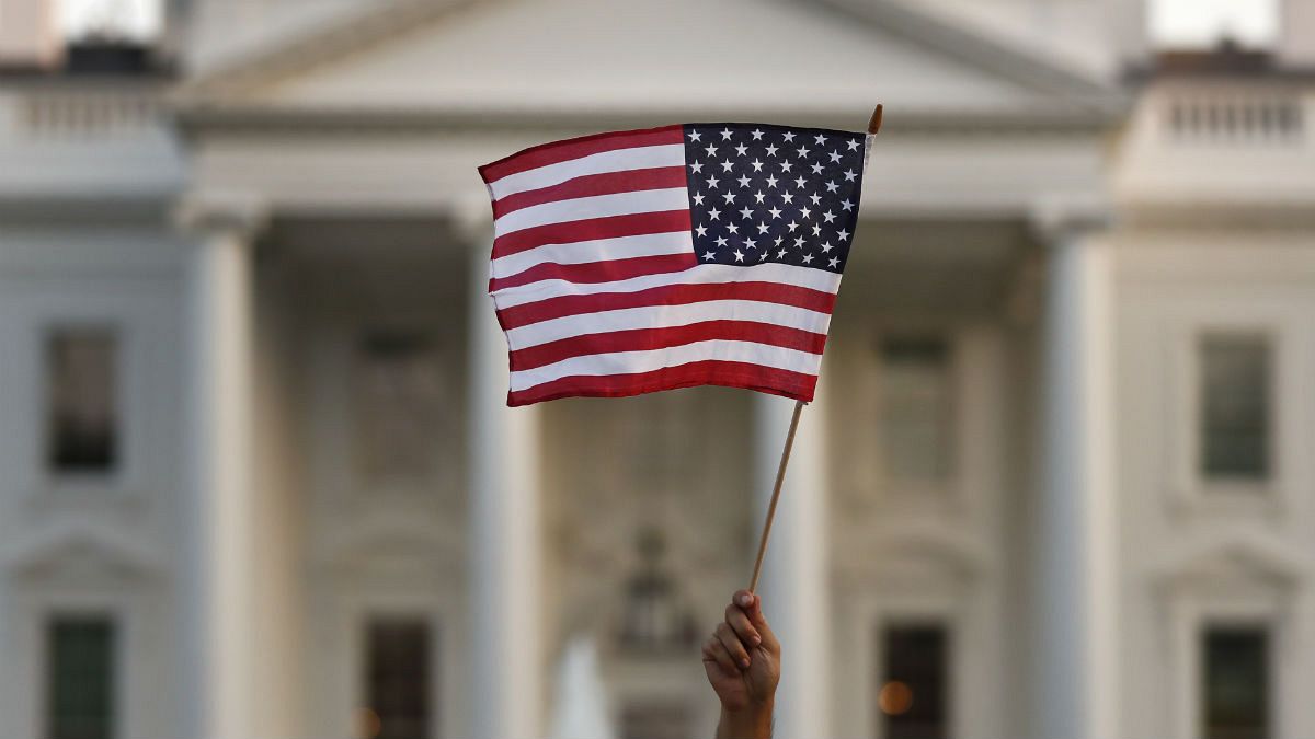  A flag is waved outside the White House, in Washington