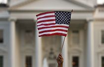  A flag is waved outside the White House, in Washington