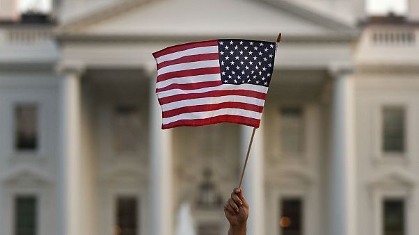 A flag is waved outside the White House, in Washington A flag is waved outside the White House, in Washington
