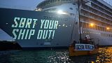 A group of 40 protesters took to the sea with banners and flags to protest The World cruise ship.